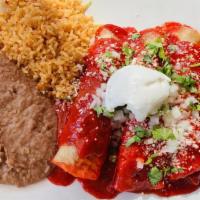 Enchiladas Verde Con Pollo · chicken wrapped in two corn tortillas and topped with tomatillo sauce and parmesan cheese