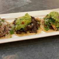 Taco Sampler · 3 mini street tacos of chicken, carnitas, pork al pastor or carne asada topped with onion, c...