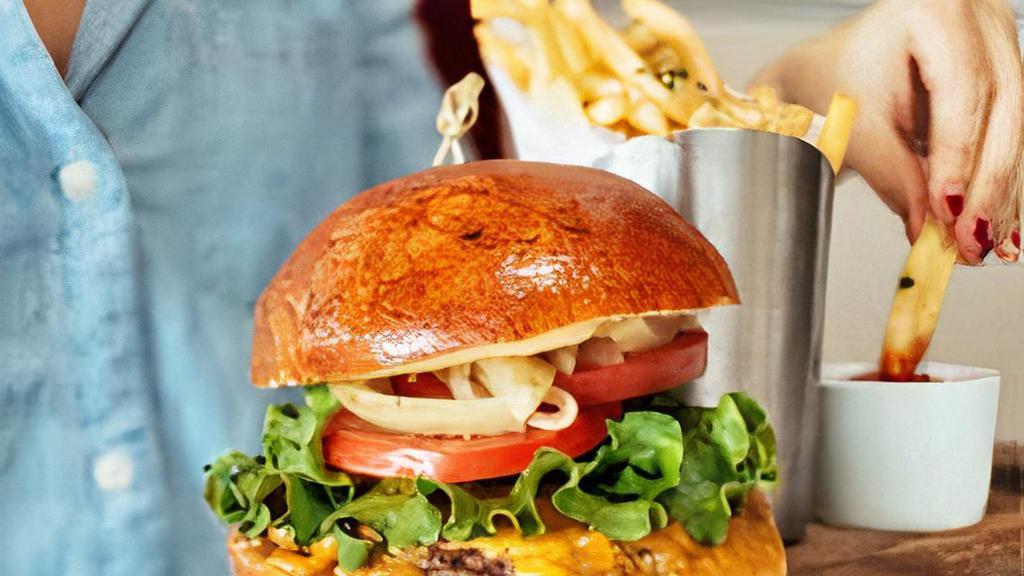 Cheese Burger · 100 percent Angus beef patty, grilled onions, cheddar, lettuce, tomato, pickles, truffle aioli, and brioche bun. Served with fries.