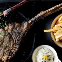 Tomahawk Steak For Two · Charbroiled prime rib with bearnaise sauce. Served with French fries and salad.