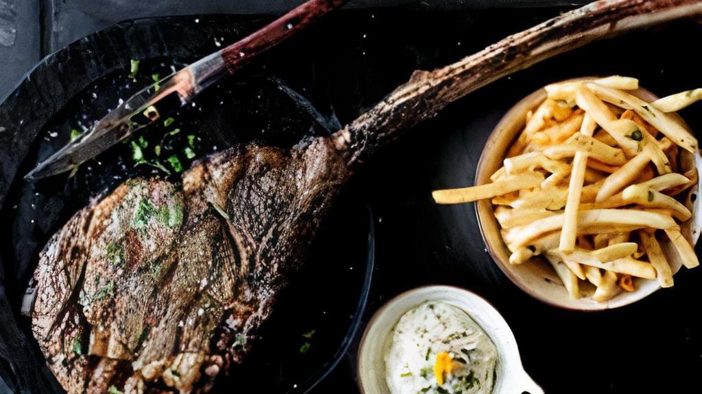 Tomahawk Steak For Two · Charbroiled prime rib with bearnaise sauce. Served with French fries and salad.