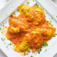 Spinach And Ricotta Ravioli · With pink sauce.