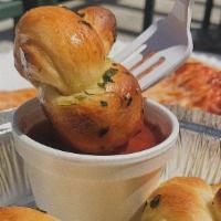 Garlic Knots · Knotted bread twists drizzled in olive oil, garlic, and parsley.