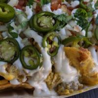Nachos · Our very own fried chips topped with beans, vegan meat, queso, onions, tomatoes, pickled jal...