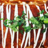 Wet Burrito · That burrito above covered in scratch-made enchilada sauce & our crema

**Our ranchera sauce...