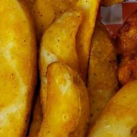 Sampler Platter · Four spicy wings, four honey BBQ wings, four chicken nuggets and 4 oz. potato wedges.