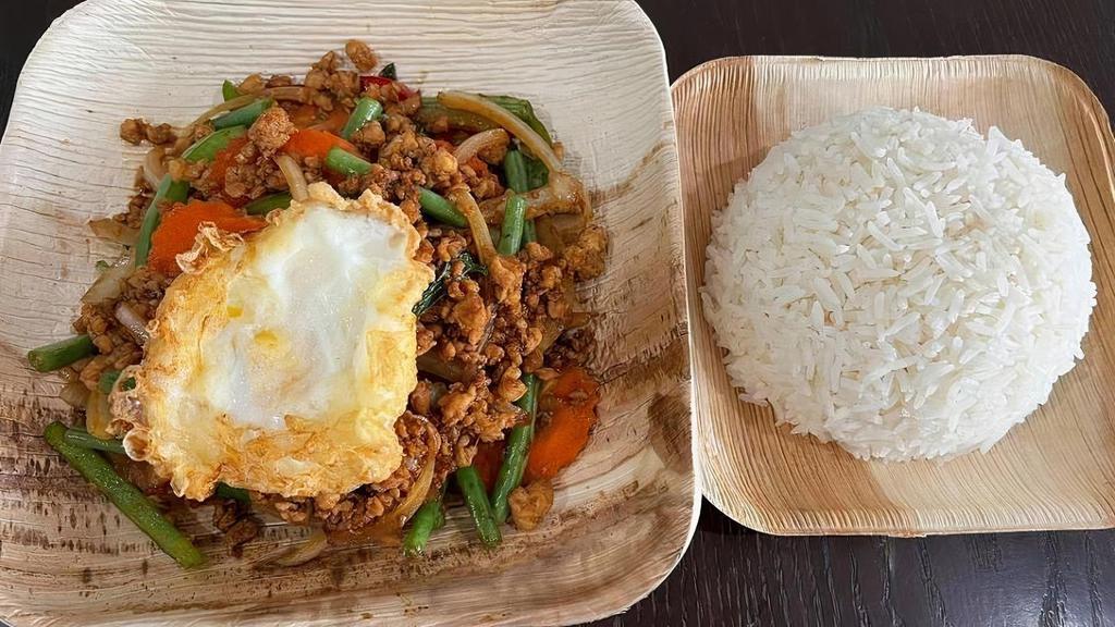Hot Basil (Pad Gaprow) · Stirfry ground chicken with garlic, bell peppers, onions, carrots, green beans, and Thai basil in spicy house chili sauce topped with fried egg.