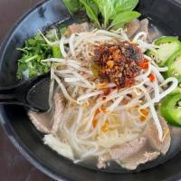 Lao Style Pho · Beef broth, rice noodles, sliced beef, meatballs and tripe. Garnished with green onion and c...