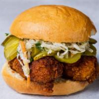 Nashville Hot Chicken Sandwich (Hot Hot) · Dipped in chili oil with spice rub, coleslaw, and cured pickles