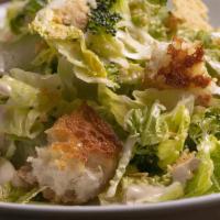 Caesar · Shaved broccoli romaine, parmesan crisps & toasted croutons with roasted garlic-parmesan dre...