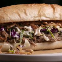 Pulled Pork · Beer braised pulled pork in a ciabatta roll with sweet cabbage slaw & crispy shallots.