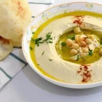 Hummus · A dip made with garbanzo beans, blended with garlic lemon juice, served with naan.