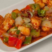 Chilly Tofu · Spicy dish. Marinated tofu in a spicy chili sauce pan tossed with onion and peppers.