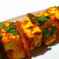 Tandoori Paneer Tikka · Diced pieces of paneer cooked in tandoor with onion and bell pepper, marinated in yogurt, sa...