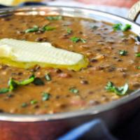 Daal Makhni · Black lentils with kidney beans cooked in slow fire overnight, tempered with butter and toma...