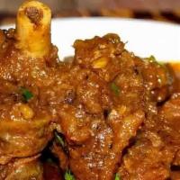 Goat Curry · Succulent pieces of goat cooked in an Indian masala sauce with fresh onion, tomato, ginger, ...