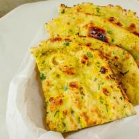Garlic Naan · Leavened bread topped with garlic and cilantro.