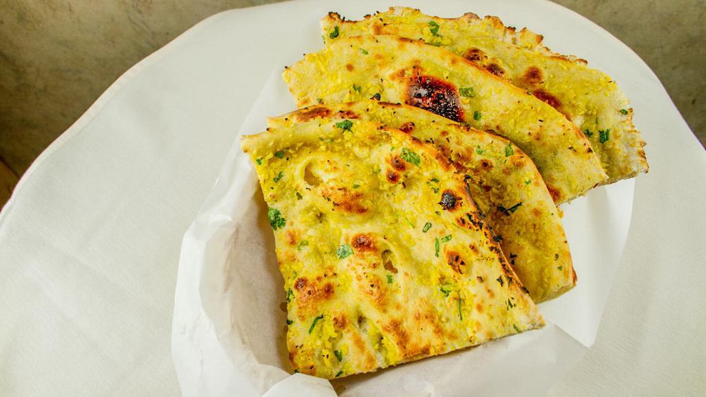 Garlic Naan · Leavened bread topped with garlic and cilantro.