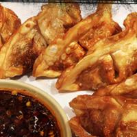 Pot Stickers · Fried chicken pot stickers served with chili soy sauce.