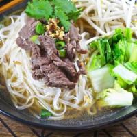 Thai Boat Noodle Soup · Tender sliced beef boiled with seasonal greens in a Thai style broth, all poured on top of a...