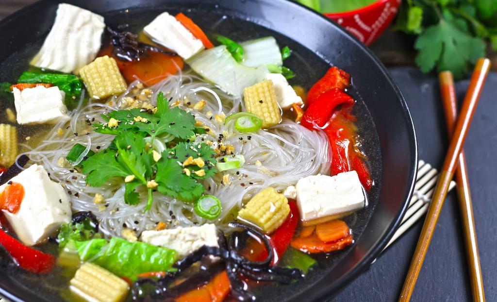 Veggie Soup · Silver noodles, steamed tofu and a large helping of seasonal vegetables boiled in a vegan broth. Garnished with roasted garlic, black pepper, green onions and cilantro. Substitute Tofu for Grilled Chickenless (VEGAN) or Vegetarian Beef for upcharge.