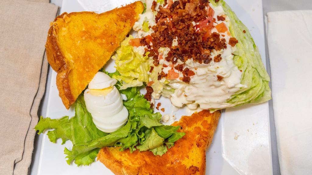 Blt Wedge Salad · Crispy iceberg lettuce wedge with diced bacon, and tomatoes. Hard-boiled egg drizzled with bleu cheese dressing and sprinkled with bleu cheese crumble.
