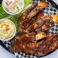Meaty Beef Ribs · With choice of one sidekick slow smoked and grilled to perfection. Served with Cole Slaw & P...