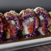 Forbidden Roll · Black rice roll topped with seared ahi, crispy onions and tempura flakes. Filled with seared...