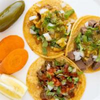 Tacos · Choice of meat, onions, cilantro, and salsa.
