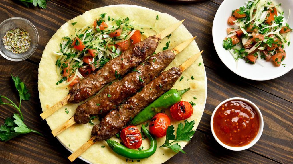 Lule Kabob Plate · Marinated Ground beef skewers grilled to perfection. Served with customer's choice of side, salad, hummus, garlic sauce, pickles and 2 pieces of pita bread.