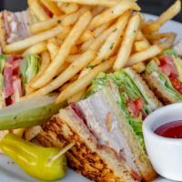 Le Grand Club Sandwich · Turkey, smoked bacon, heirloom tomato, iceberg lettuce, avocado aioli, and french white. Ser...