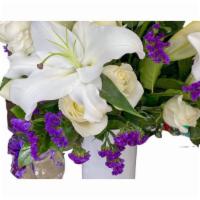 Traditional Sympathy Arrangement · Traditional sympathy arrangement with elements of lilies, eucalyptus, white roses, and white...