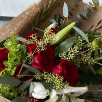 Rustic Christmas Bouquet · Enjoy the Christmas holiday with a beautiful rose, Lily, and eucalyptus arrangement. Wrapped...