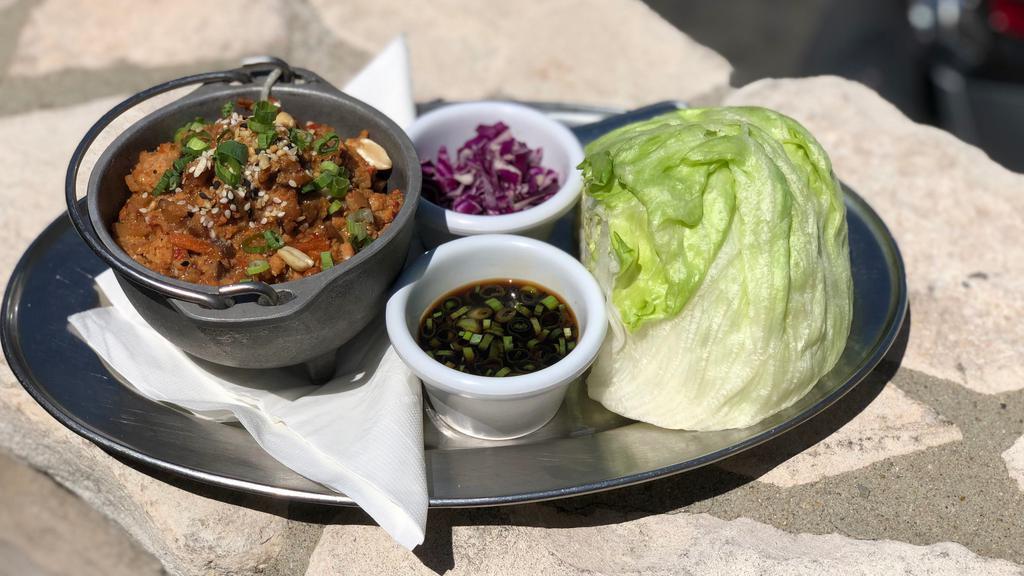 Spicy Chicken Lettuce Wraps · Spicy. A fresh and flavorful blend of chicken, shiitake mushrooms, garlic, ginger and red bell peppers, topped with green onions, sesame seeds and peanuts. Served with fresh lettuce cups and a spicy ponzu sauce.