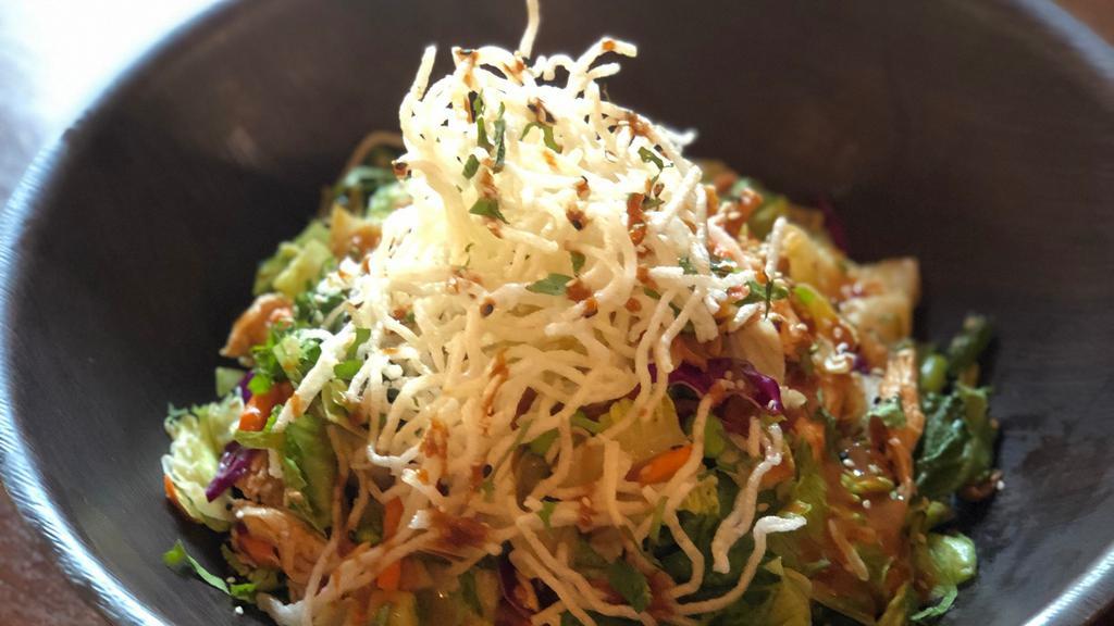 Thai Peanut Crunch Salad-Lighter · Crisp romaine lettuce, pulled chicken breast, carrots, cucumbers, cilantro and rice noodles, wonton strips, peanuts, edamame and sesame seeds and all tossed with Thai peanut dressing. Add grilled or bbq chicken, or salmon or steak for an additional charge.
