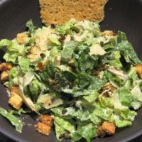 Caesar · Crispy romaine lettuce tossed with caesar dressing, shaved parmesan cheese, fried capers and...
