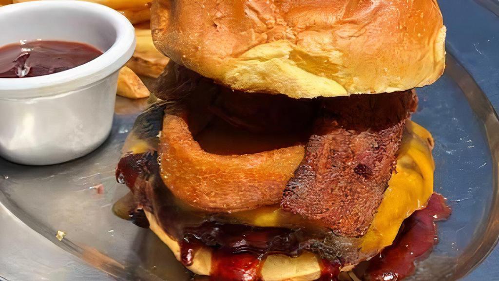 Bbq Burger · Smothered in BBQ sauce and topped with three-pepper bacon, cheddar cheese and onion rings, on a toasted brioche bun.