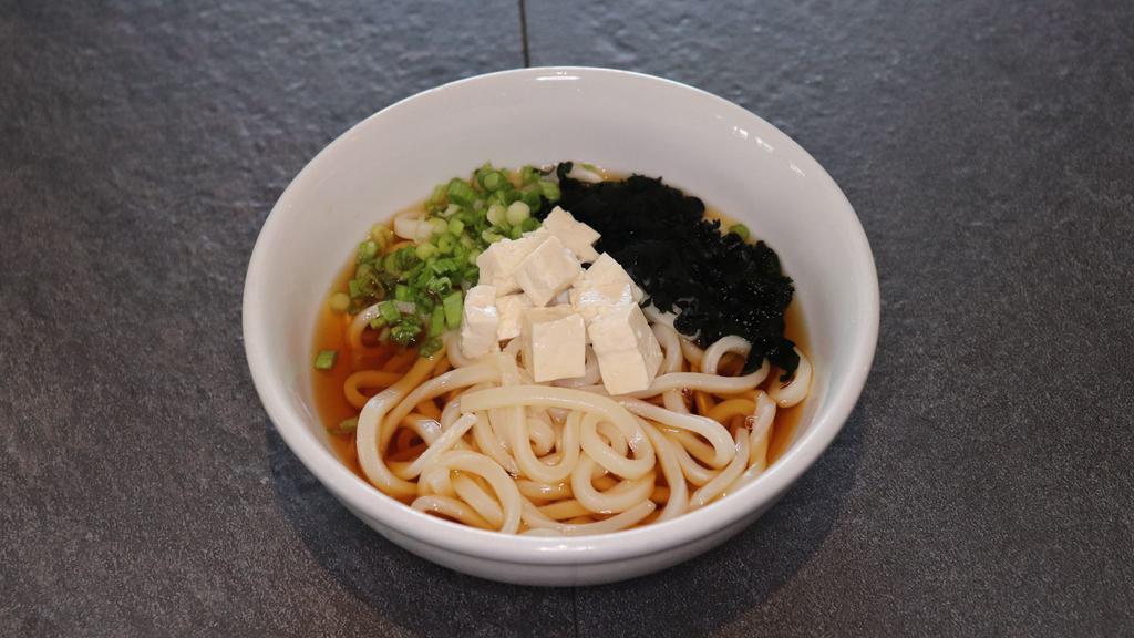 Udon Noodle Soup · Thick, wheat-flour noodle served with tofu, green onion, and wakame (seaweed) in udon broth.