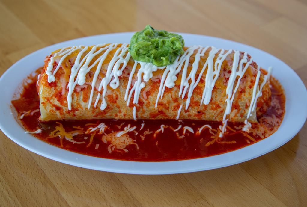 Wet Burrito · Rice, whole beans, onion, cilantro, wrapped in a flour tortilla topped with housemade salsa, topped with  cheese, crema, guac.