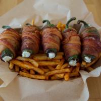Jalapeño Poppers (5 Pcs) · Jalapeño and cream cheese warped in bacon with fries