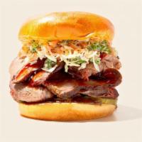 Bbq Brisket Sandwich · Smoked and sliced beef brisket with bbq sauce on a fluffy bun and coleslaw on the side