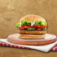 Falafel Feast · Crispy falafel patty, Mediterranean style with fresh greens, pickles, shaved onions, Roma to...