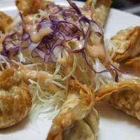 N-67. Fried Dumplings 12 (튀김만두/油炸饺子) · (튀김만두/油炸饺子): Deep-fried dumplings with pickled radish and cabbage salad. Served 12 pieces. T...