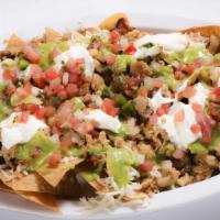 Nachos Supreme  · Cheese nachos with assorted topics of ground beef, shredded chicken and refried beans. All c...