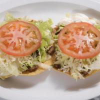 Tostadas De Carne #26  · Two tostadas with the choice of meat that you'd like, beans, lettuce, cheese, tomato, sour c...
