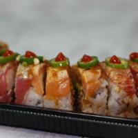 Cosmopolitan Roll · Inside stuffed with shrimp tempura, spicy tuna, and avocado. Outside seared Cajun tuna, Caju...