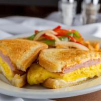 Breakfast Sandwich · Ham, American and Swiss cheese, and scrambled eggs on sourdough. Served with choice of potat...