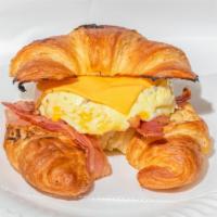 Croissant Breakfast · Croissant, scrambled eggs, cheese, & one meat choice (bacon, sausage, turkey, ham, roast bee...