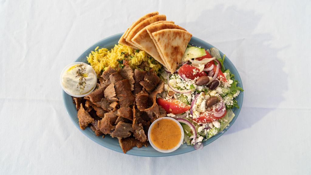 Gyro Plate · Grilled pita bread with shaved gyro, crumbled feta, fresh tomatoes, red onions, lettuce, and tzatziki sauce served with rice or fries. Served with choice of soup or house salad.