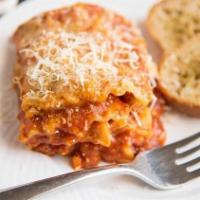 Lasagna · With garlic bread, meat and veggies.
